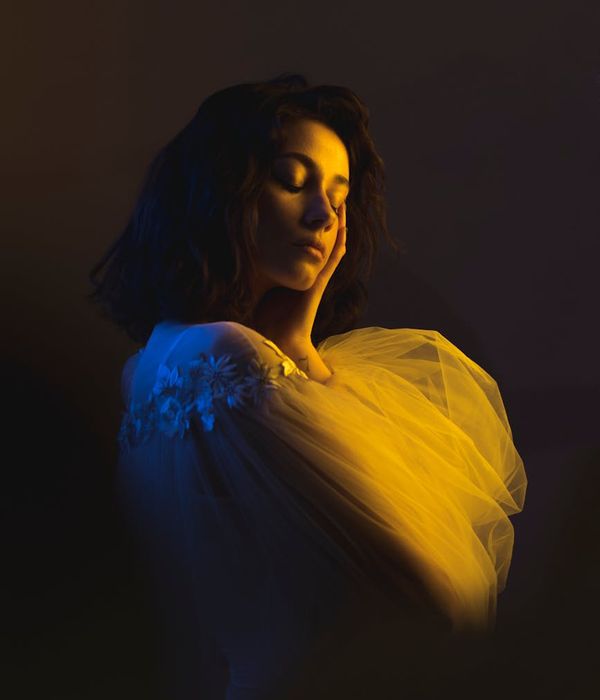 Woman in a dynamic yet gentle cardio pose in a studio with soft lighting.